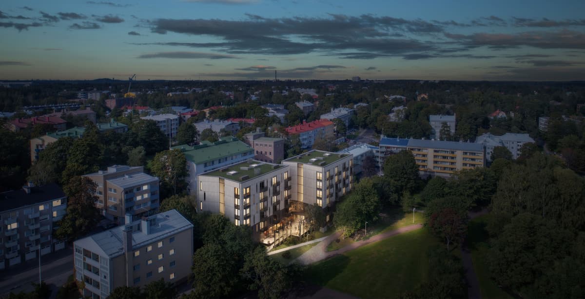 En visualiseringsbild på Folkhälsanhuset i Haga ovanifrån. Flygfoto över ett modernt bostadshus i en grönskande stadsdel under kvällstid.